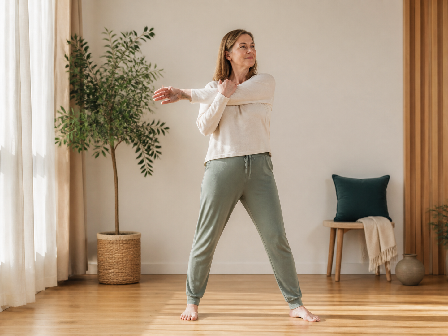 Woman doing a gentle standing mobility stretch at home